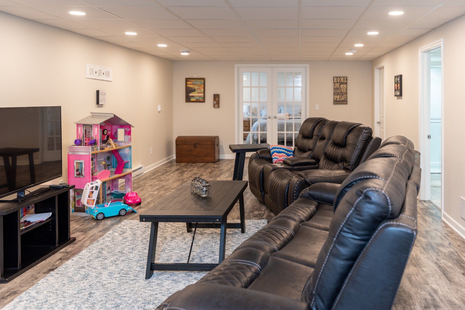 A living room with a couch , table , and television.