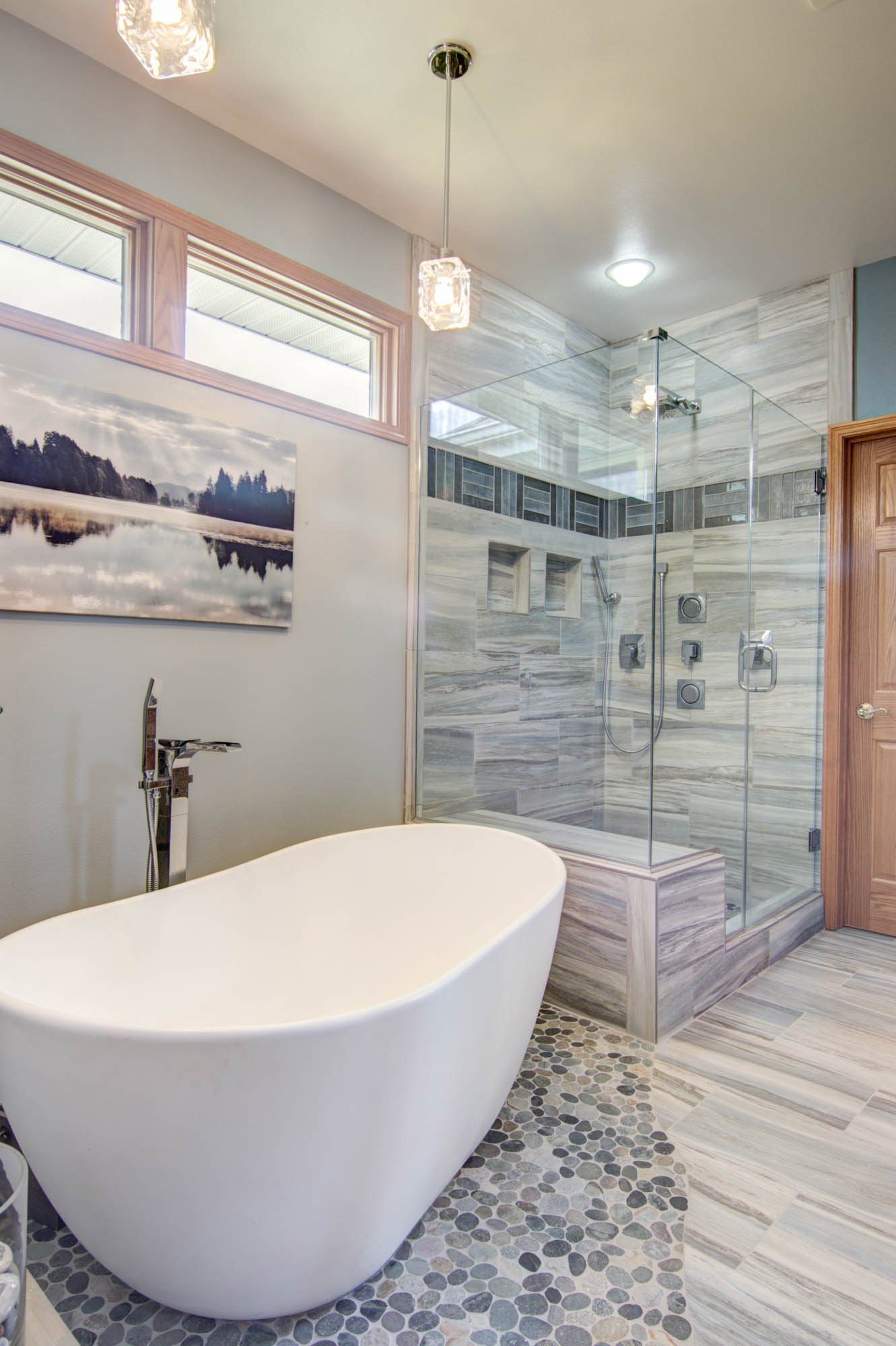 A bathroom with a bathtub and a walk in shower.