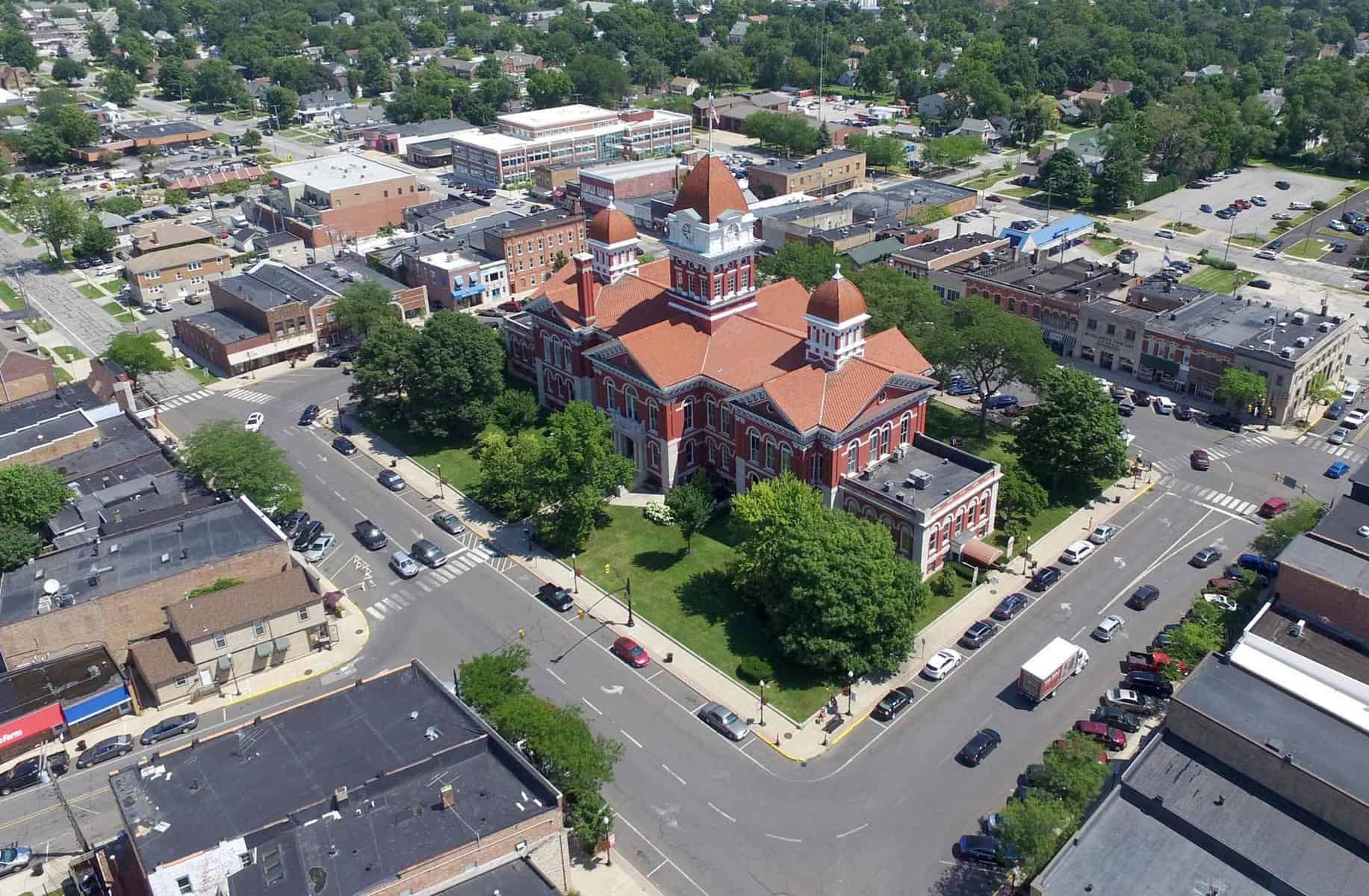 An aerial view of a small town with a large brick building in the middle.