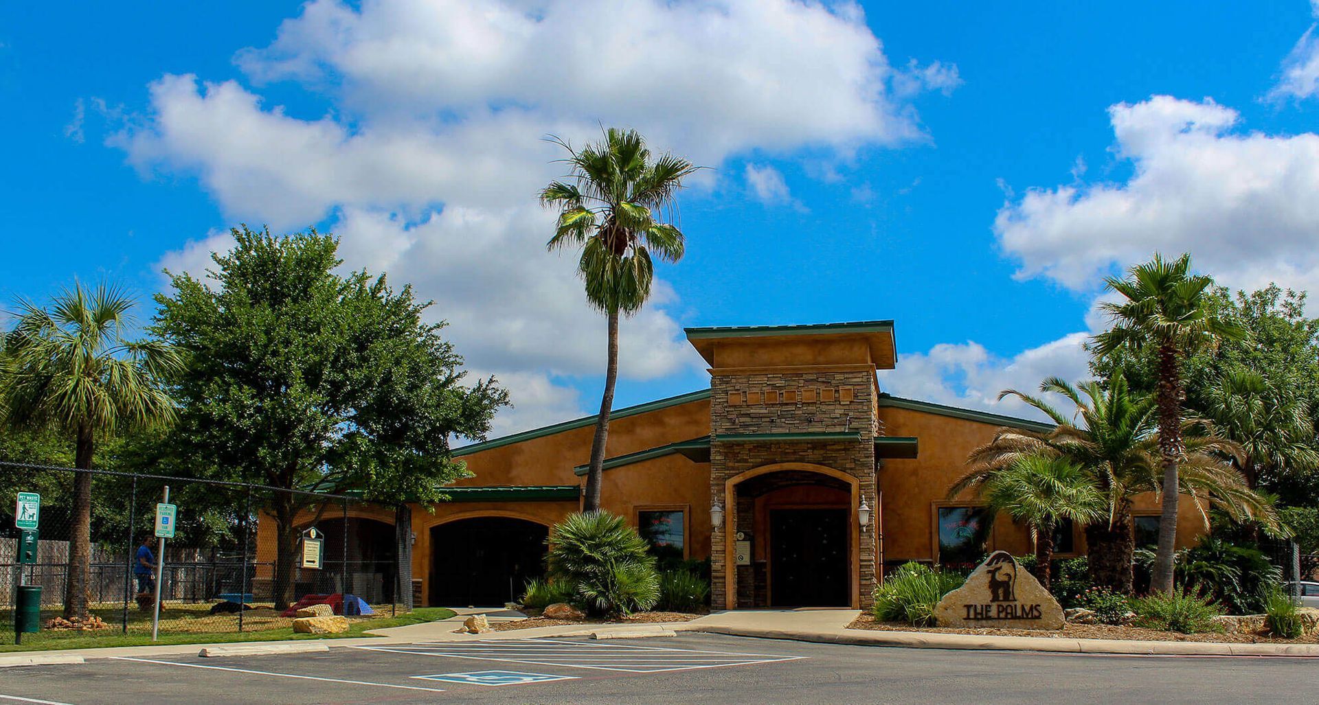 A large building with a palm tree in front of it.