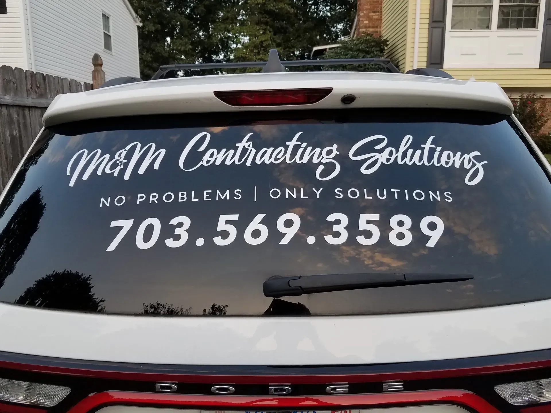 Car rear window decal for M&M Contracting Solutions with phone number 703.569.3589