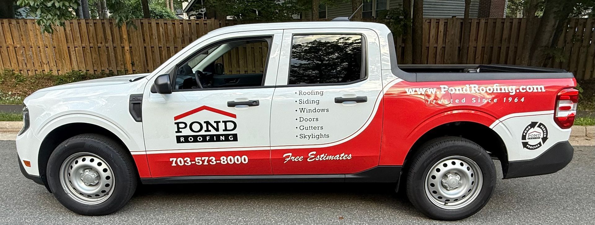 White and red pickup truck with Pond Pester service branding parked in front of a fence