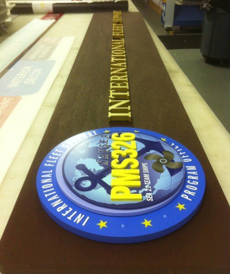Blue International Floorball Federation PASS26 badge on a brown belt-like surface, viewed from above