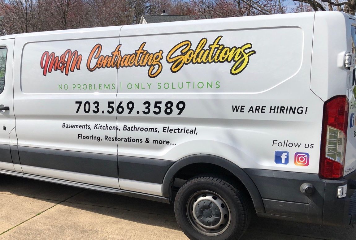 White HVAC service van with “Heating Cooling Solutions” lettering and contact info, parked outdoors
