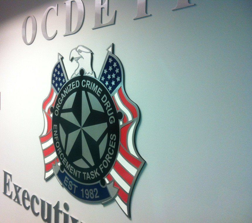 Wall sign with an Oklahoma Department of Corrections anti-crime task force emblem and US flag motif