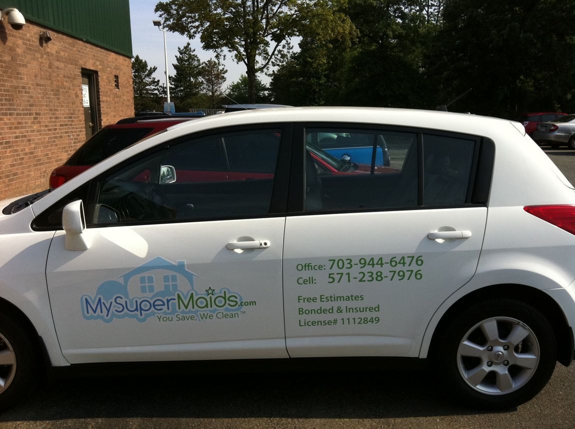 White “My Super Molds” sedan parked outdoors with company contact info on the side