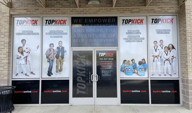 Topkixx storefront with large promotional posters on a brick building entrance