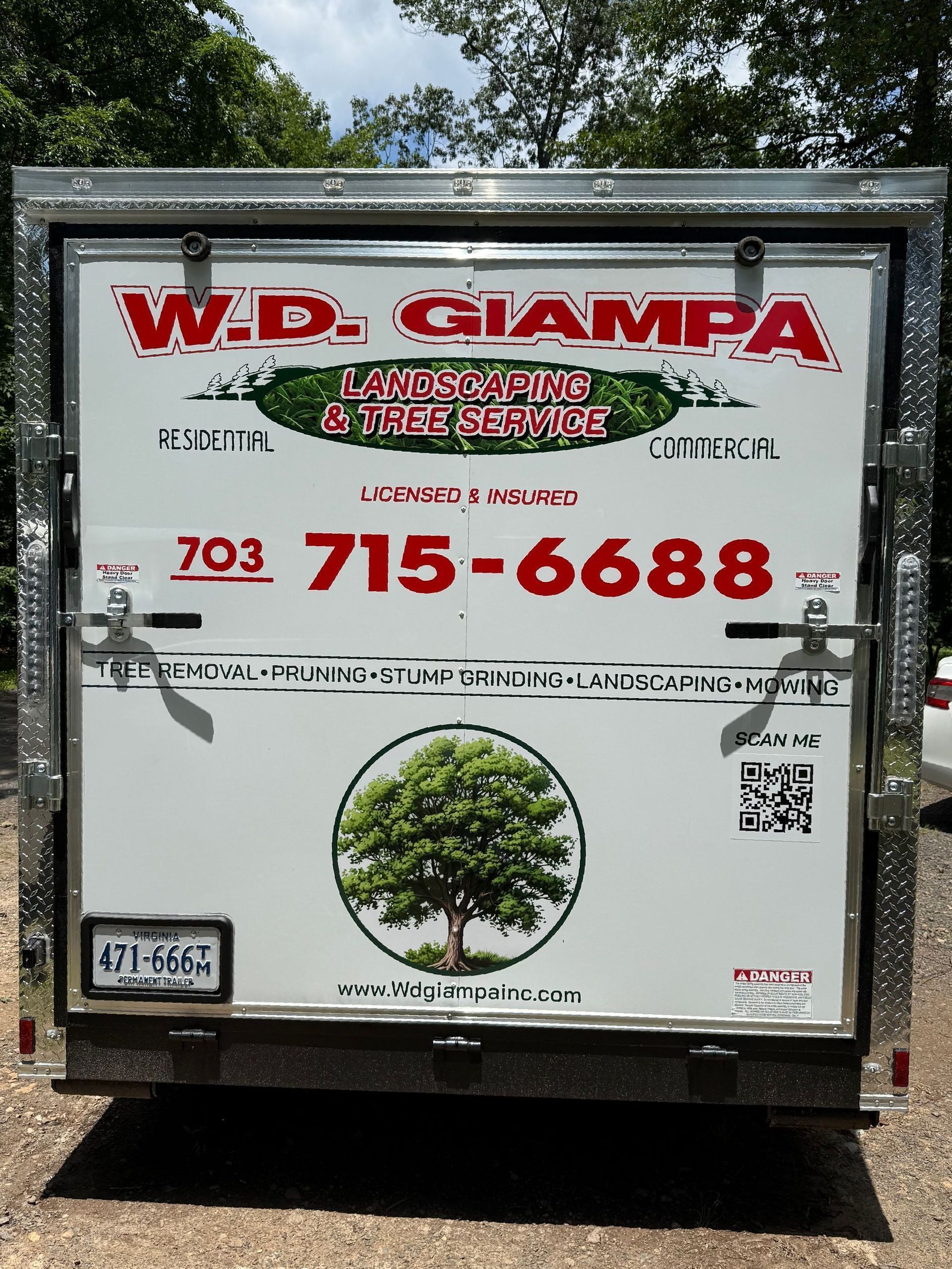 White W.D. Ciampa service truck with large red phone number and tree logo on the rear door
