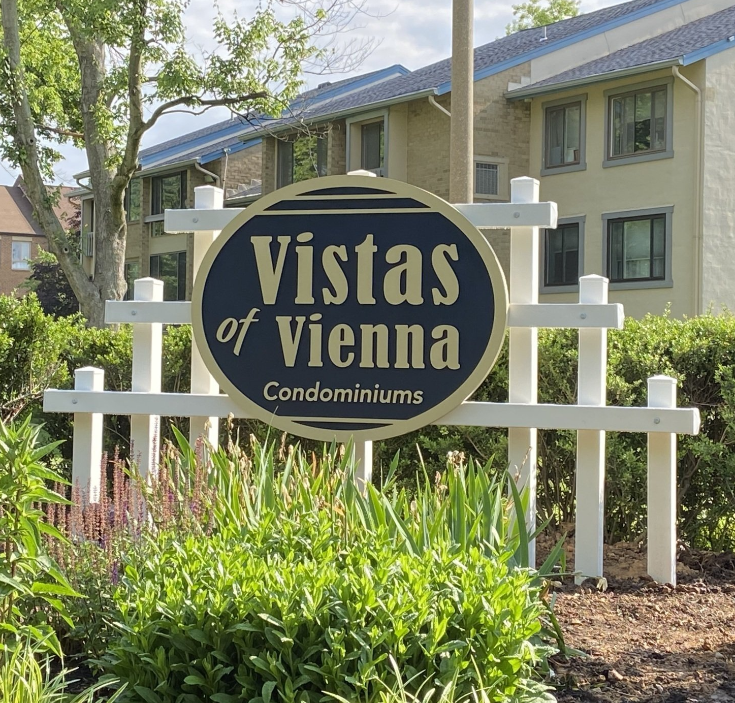Vistas of Vienna Condominiums sign in front of apartment buildings and greenery