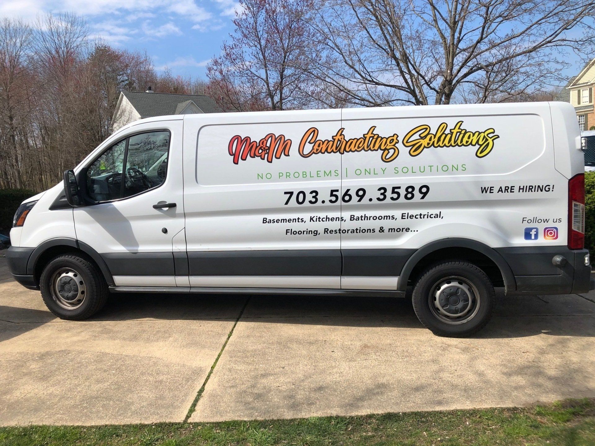 White service van with “Mister Electric” branding parked in a driveway under trees