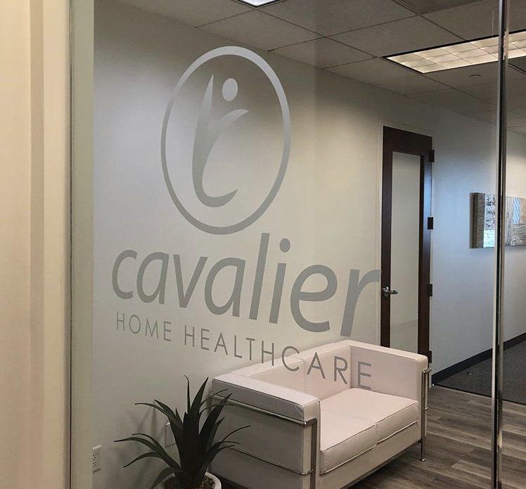 Cavallier Home Healthcare office lobby with frosted glass logo and white bench seating