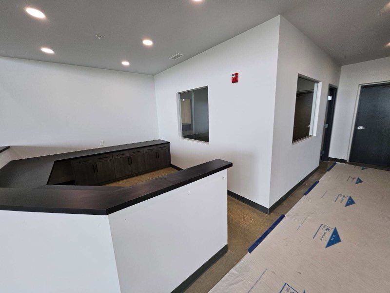 A hallway with a counter and a window in a building.