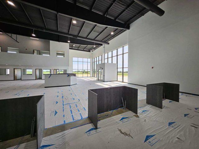A large empty room with a lot of windows and a ceiling.