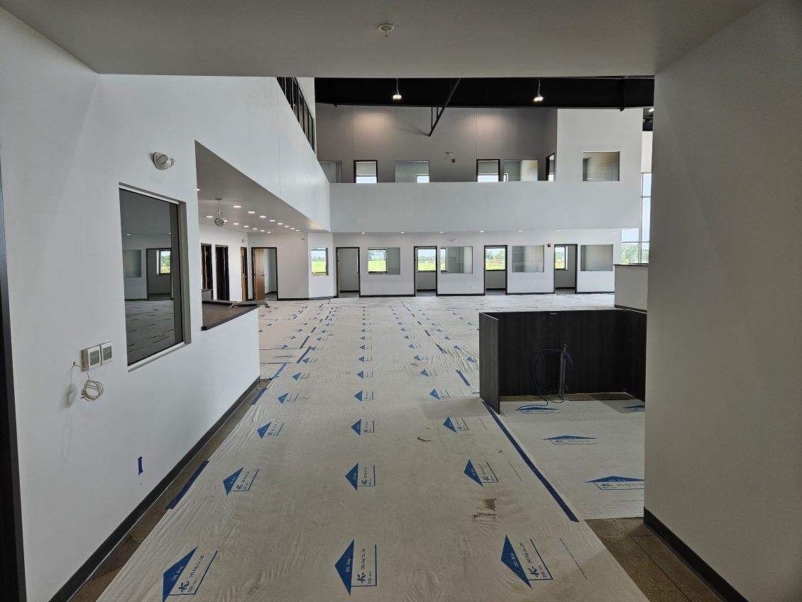 A hallway in a building under construction with a lot of windows.