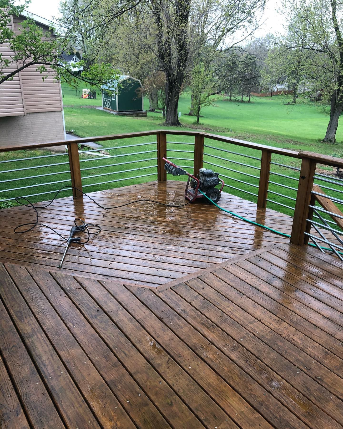 A screened in porch with a wooden deck and a sliding glass door.