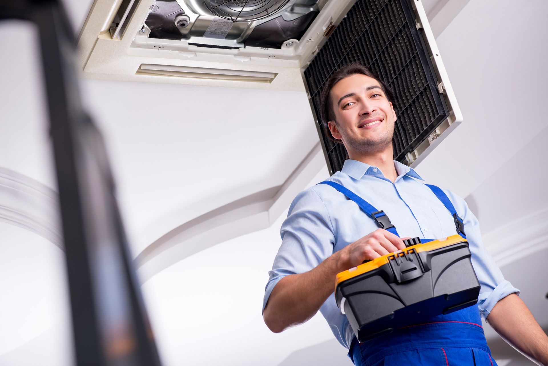 AC contractor inspecting an indoor air conditioning unit