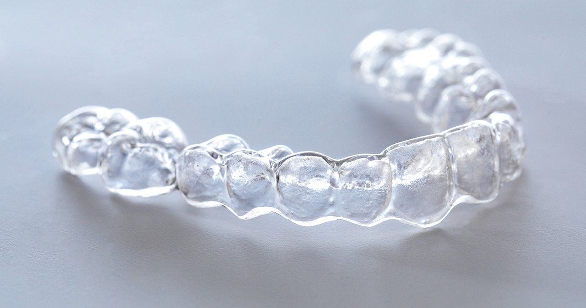 Clear, plastic orthodontic aligner, used for straightening teeth.