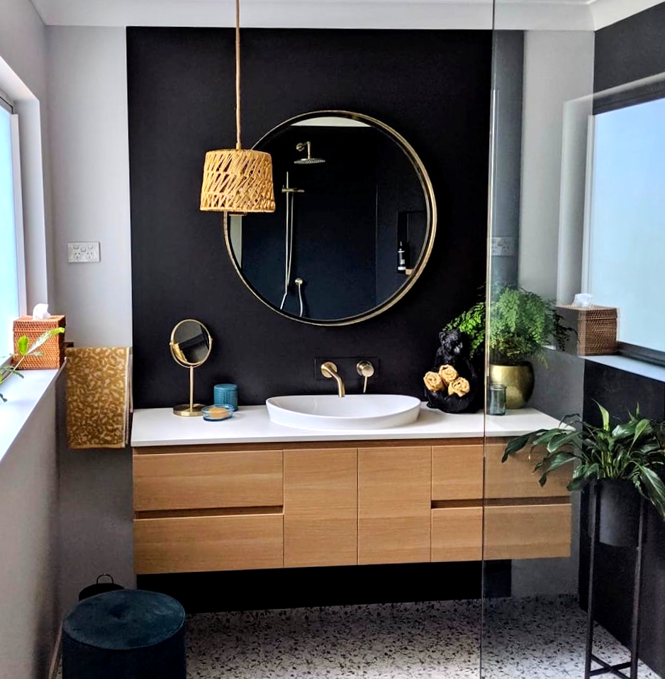 Man Installing Kitchen Cabinets in A White Kitchen — Lukas Joinery in Belmont, NSW