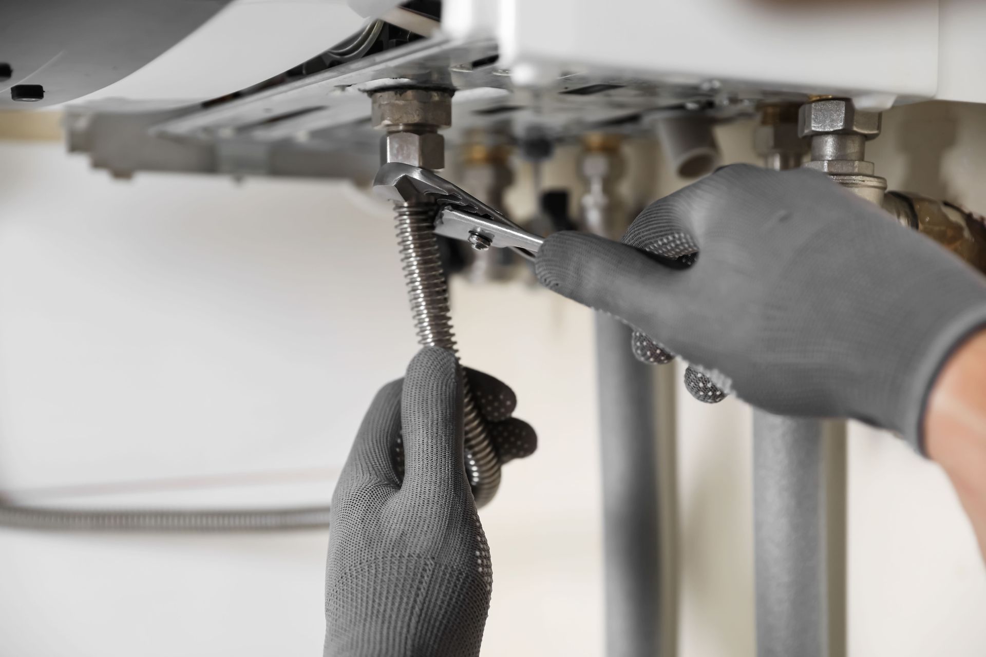 Man Repairing Hot Water System | Canberra, ACT | Plumbworks