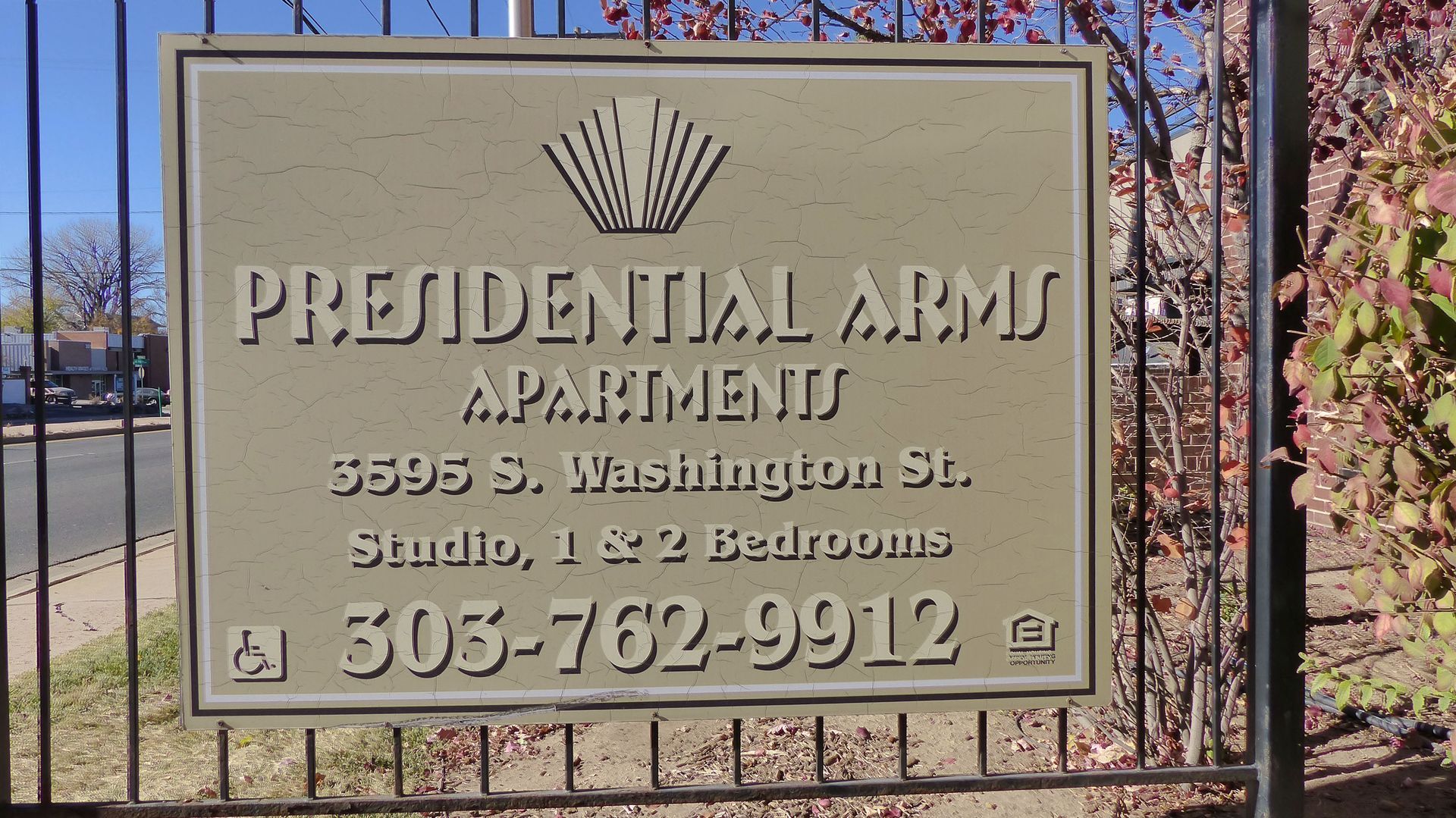 Sign for Presidential Arms Apartment with address, Glendale, and phone number in front of a fence