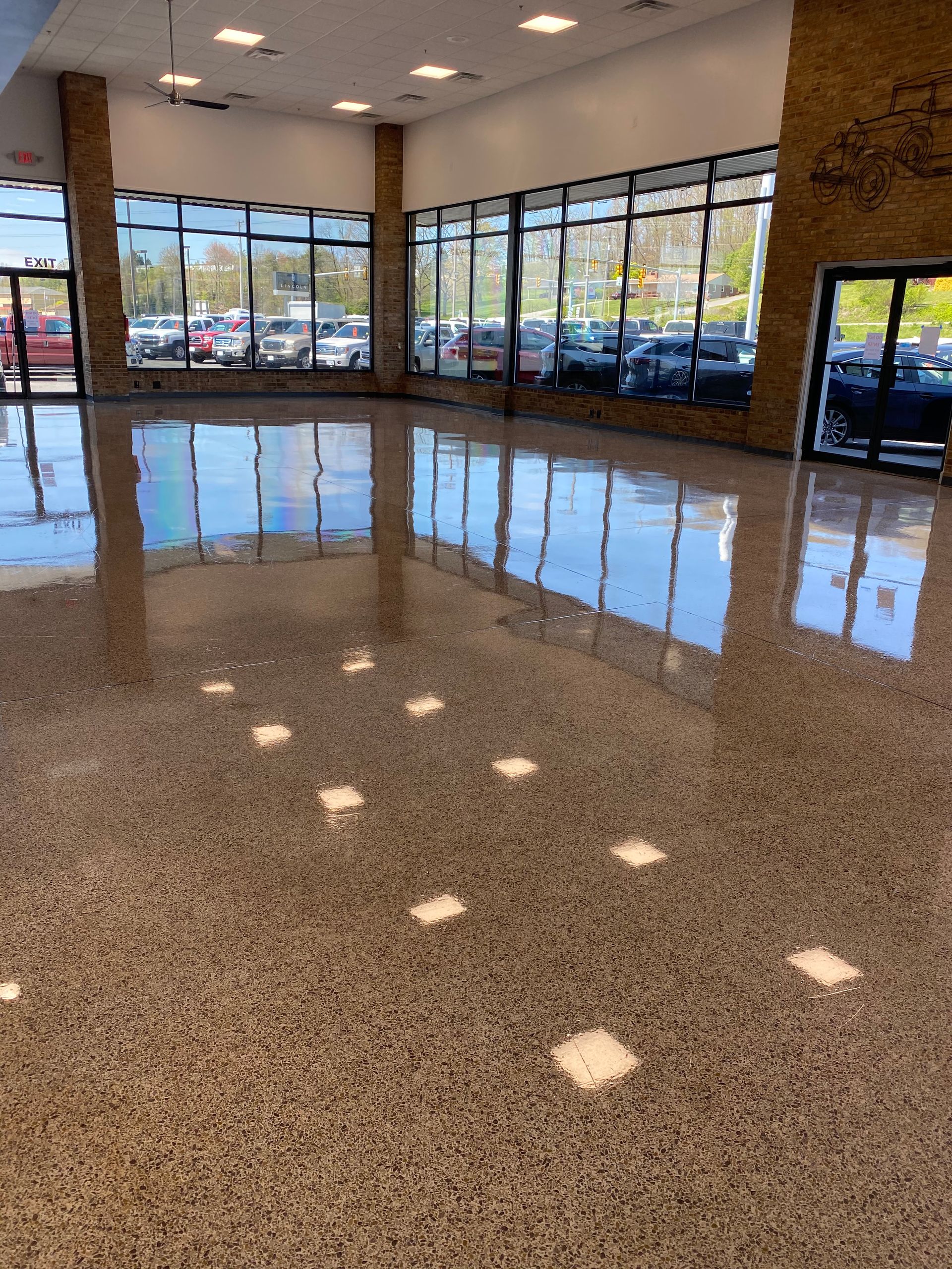 A large room with a lot of windows and a shiny floor