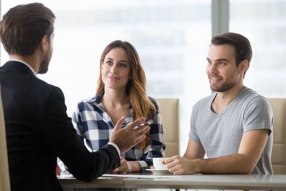 financial advisor making presentation offer to clients at meeting in office