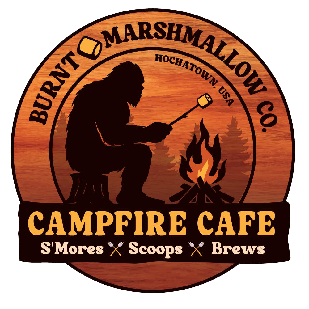 Burnt Marshmallow Co. Campfire Cafe logo with camper roasting marshmallows over a fire on a wood-grain circle