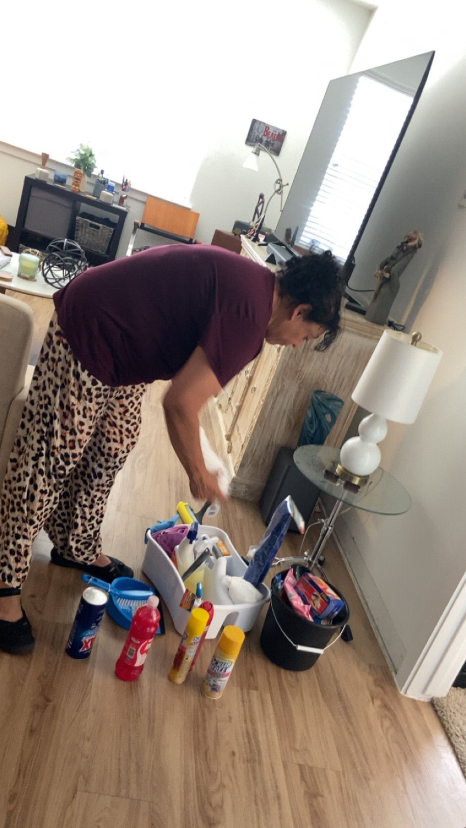 Two people unpacking boxes in a bright room, with one organizing items on a table.