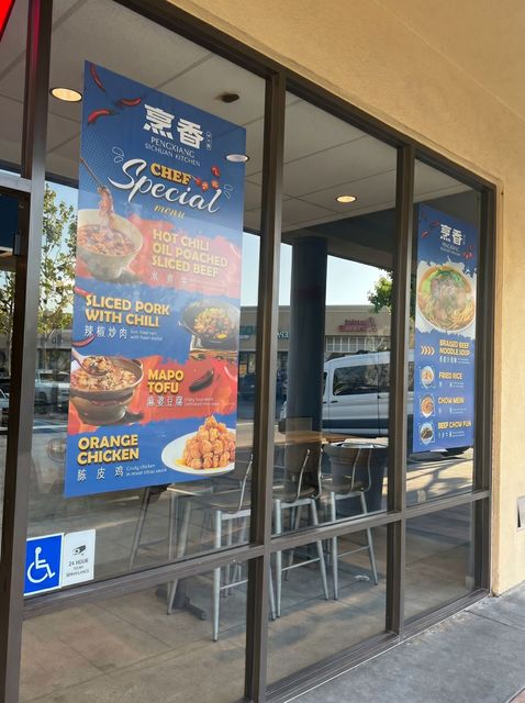 Restaurant storefront with blue seafood special posters on glass doors and windows