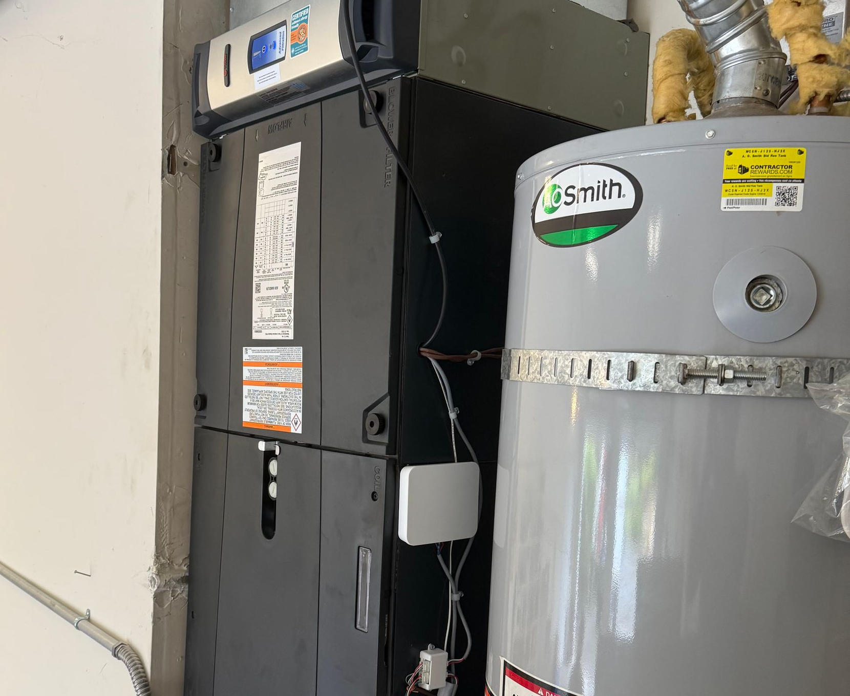 Residential furnace and water heater system installed in home utility area