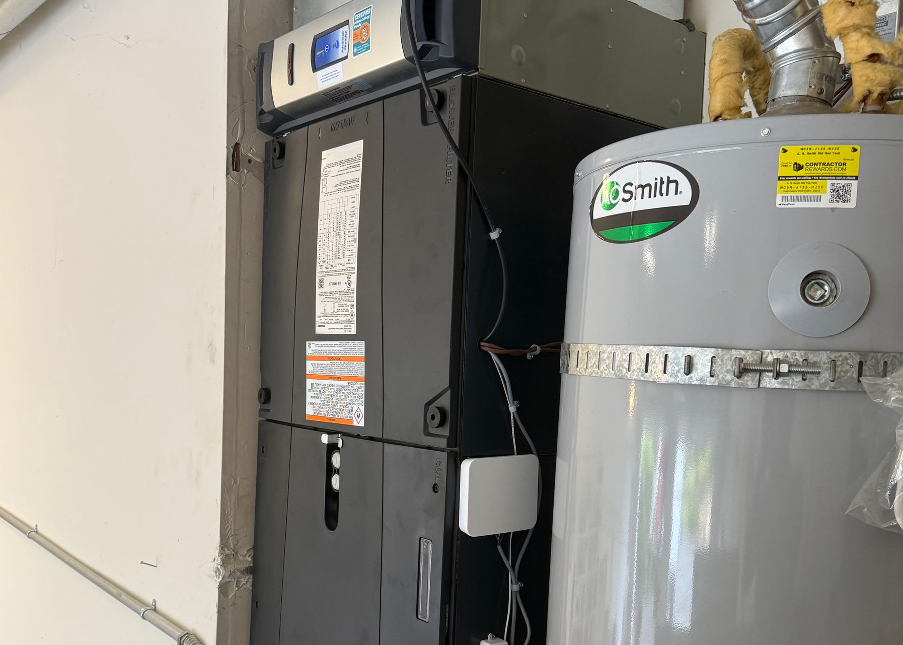 Residential furnace and water heater system installed in home utility area
