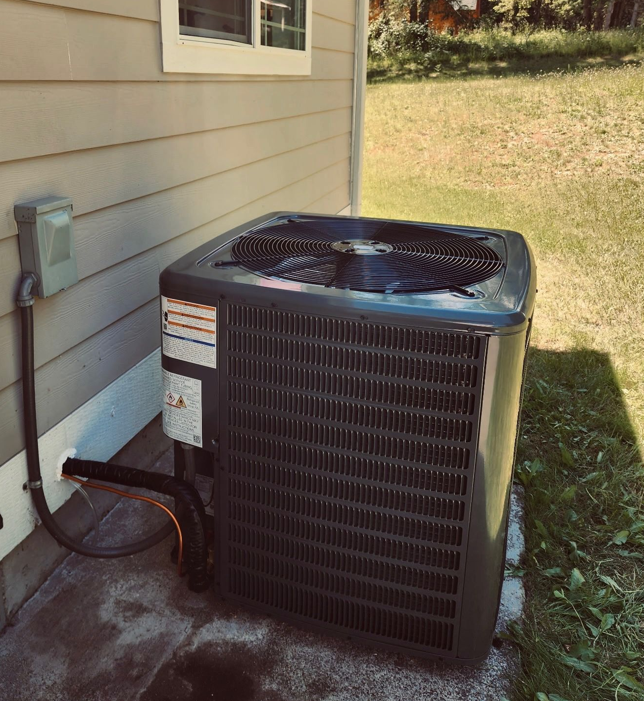 Air conditioning system installation outside a home in Belfair, WA