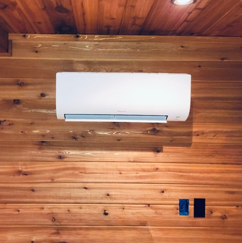 Wall-mounted mini split heat pump installed in a finished interior space