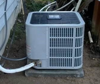Central air conditioning unit installed outside home in Belfair WA