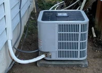 Central air conditioning unit installed outside home in Belfair WA