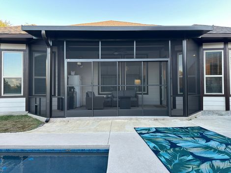 Screened-in porch overlooking a landscaped backyard