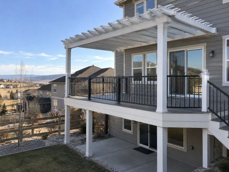Cedar pergola with louvered motorized roof over a stone patio