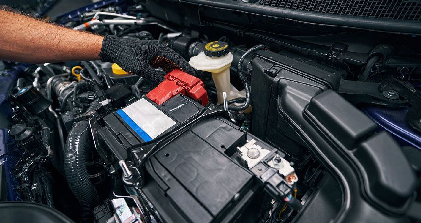 Mechanic inspecting a car battery