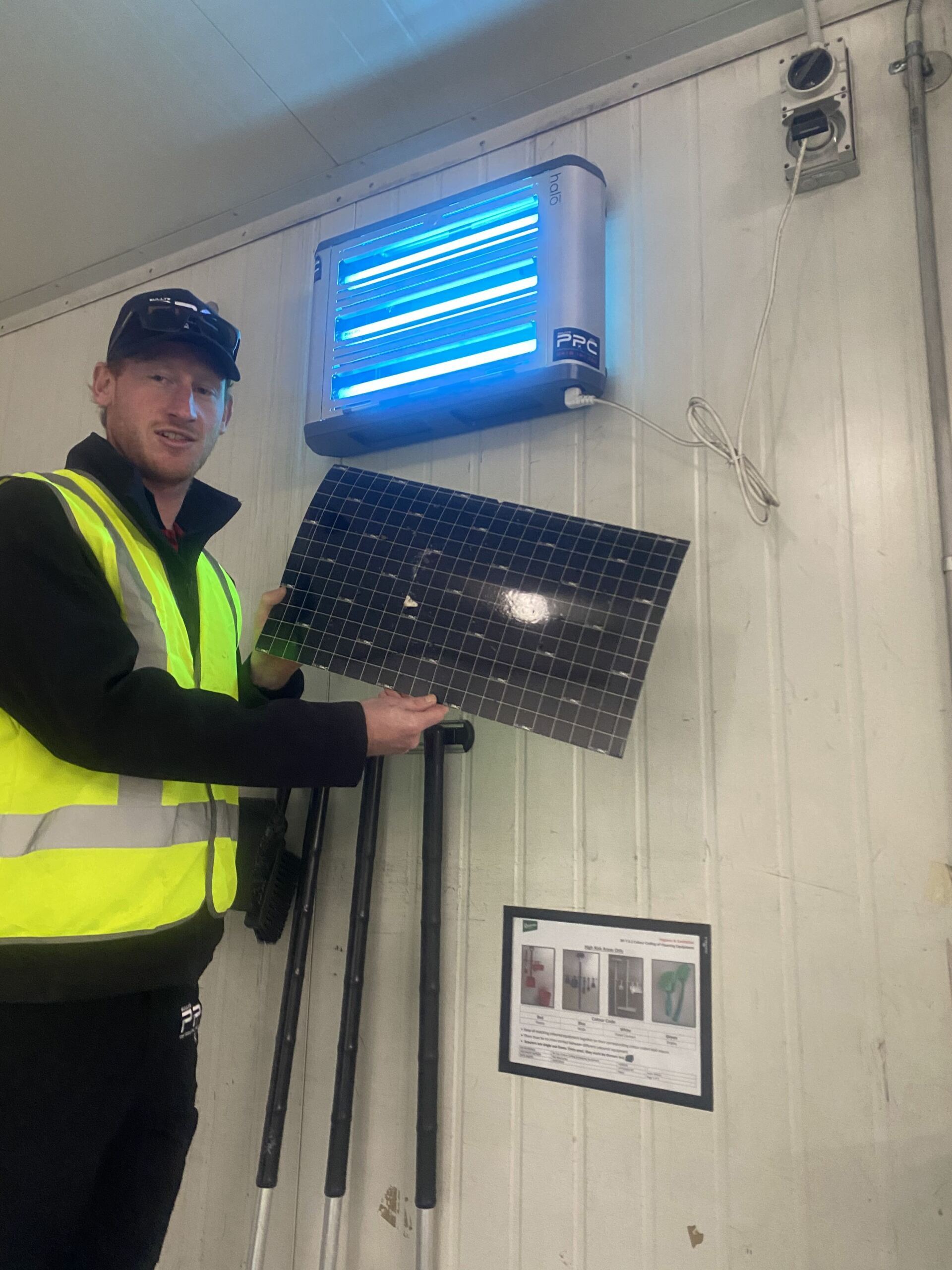 Technician replacing Fly Trap — Professional Pest Control In Thurgoona NSW