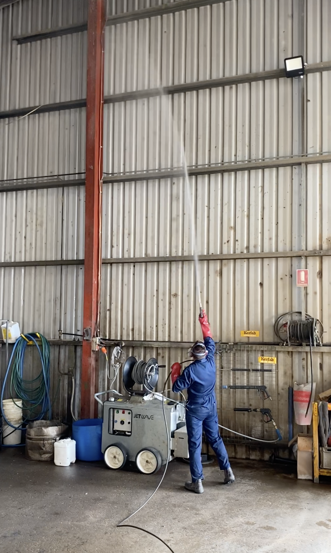 Technician wearing full PPE and Spraying — Professional Pest Control In Thurgoona NSW