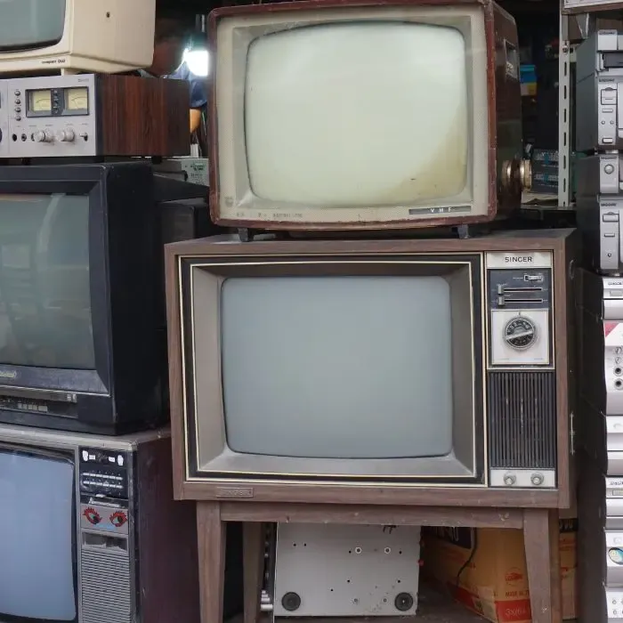 a bunch of old televisions are stacked on top of each other