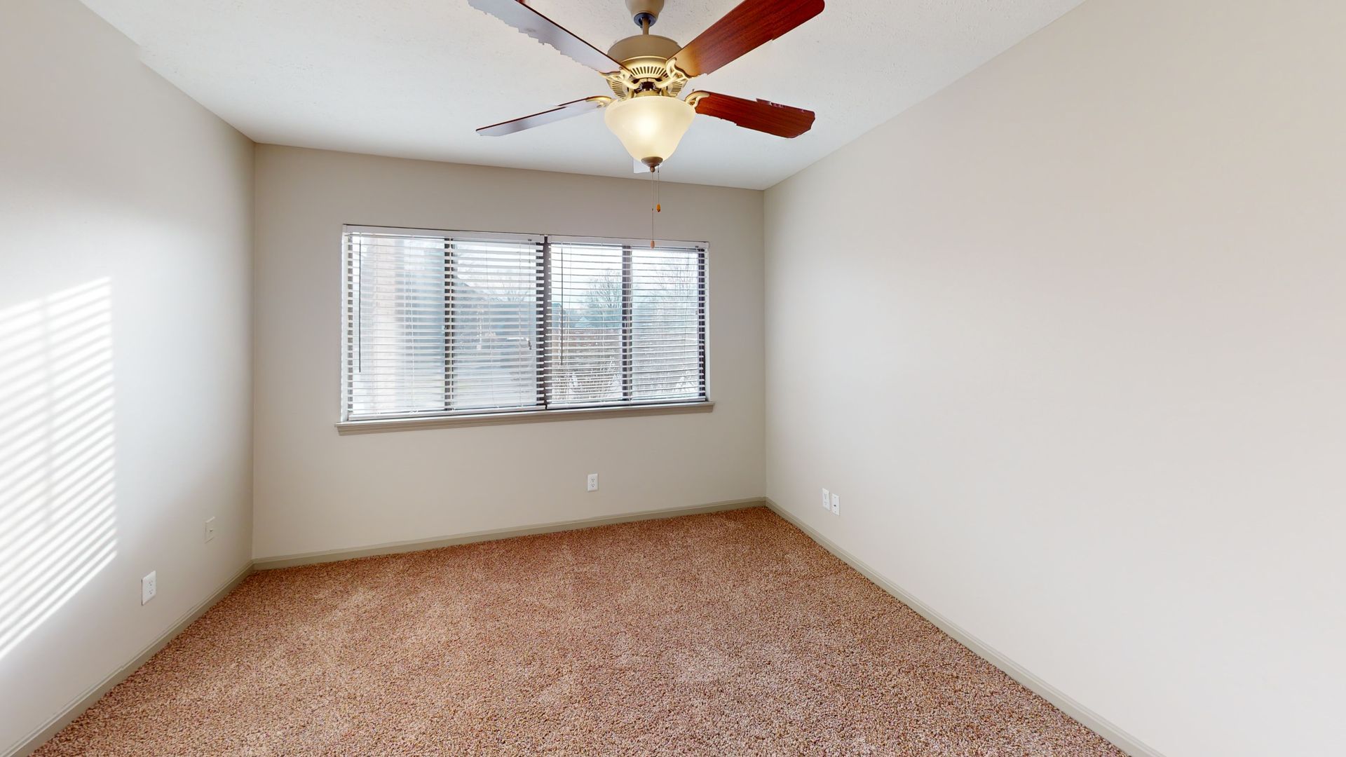 Bedroom featuring a fan and large windows