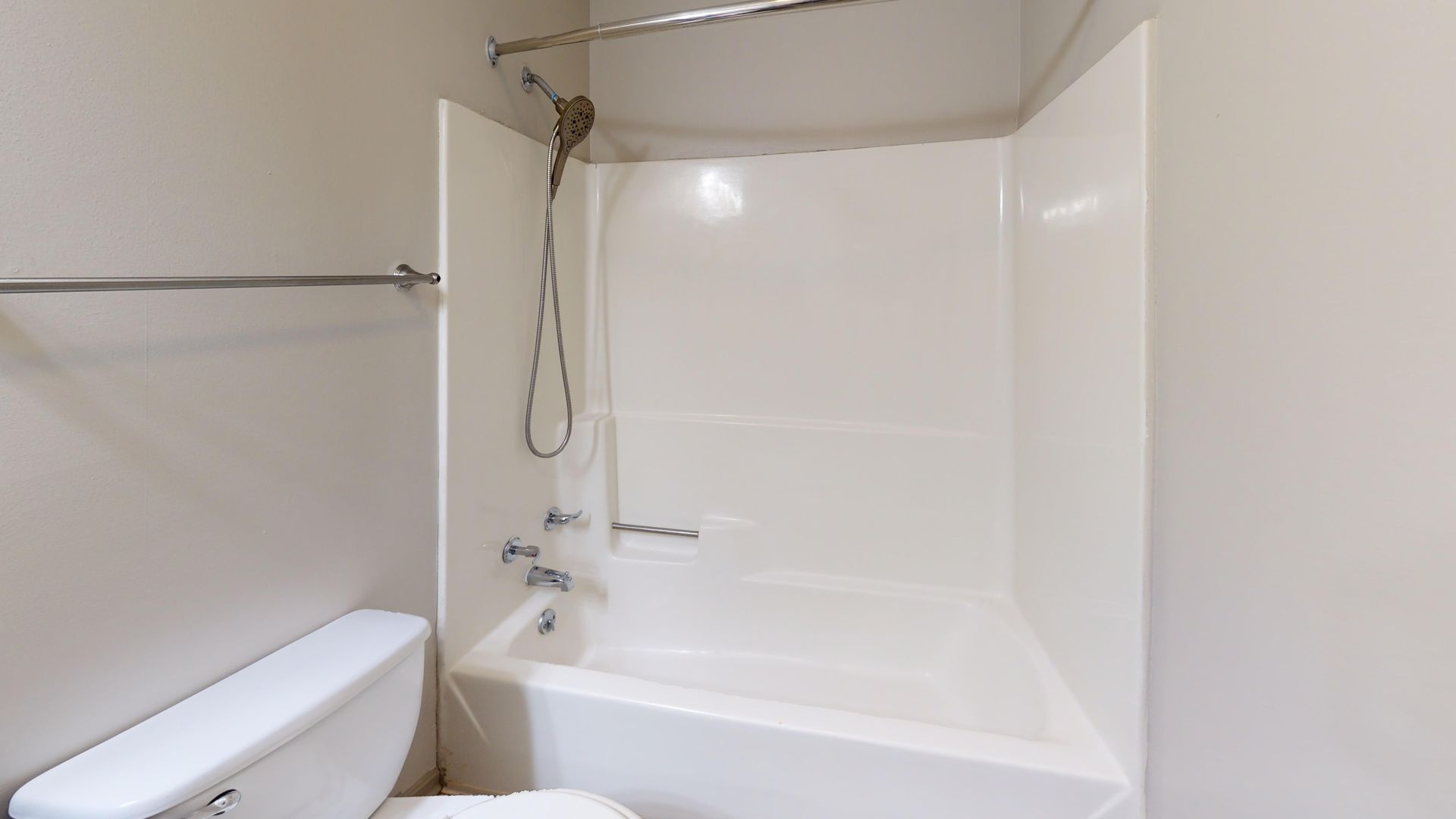 Bathroom with a toilet and a bath/shower combo