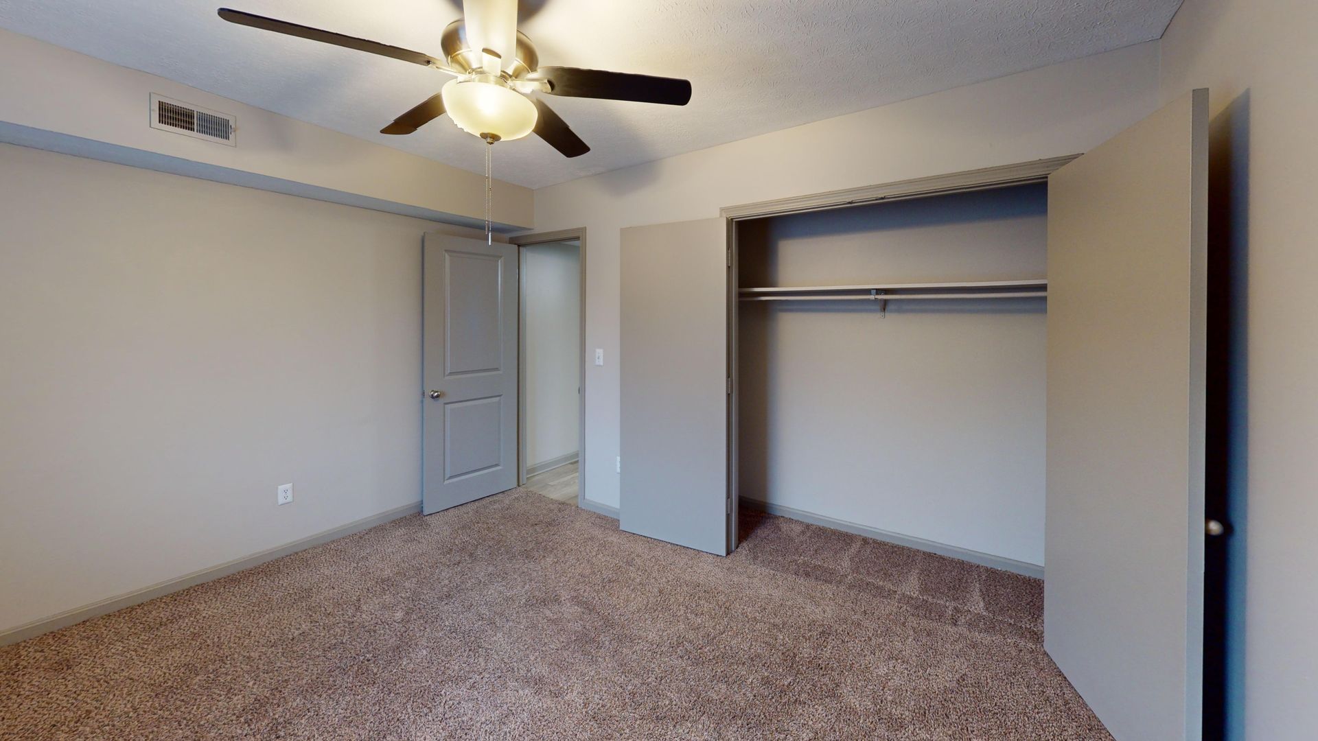 Bedroom featuring a fan and a large closet