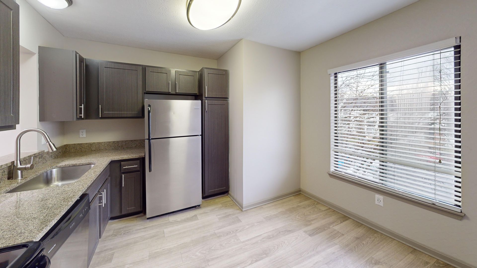 Kitchen with brown cabinets and stainless steel appliances