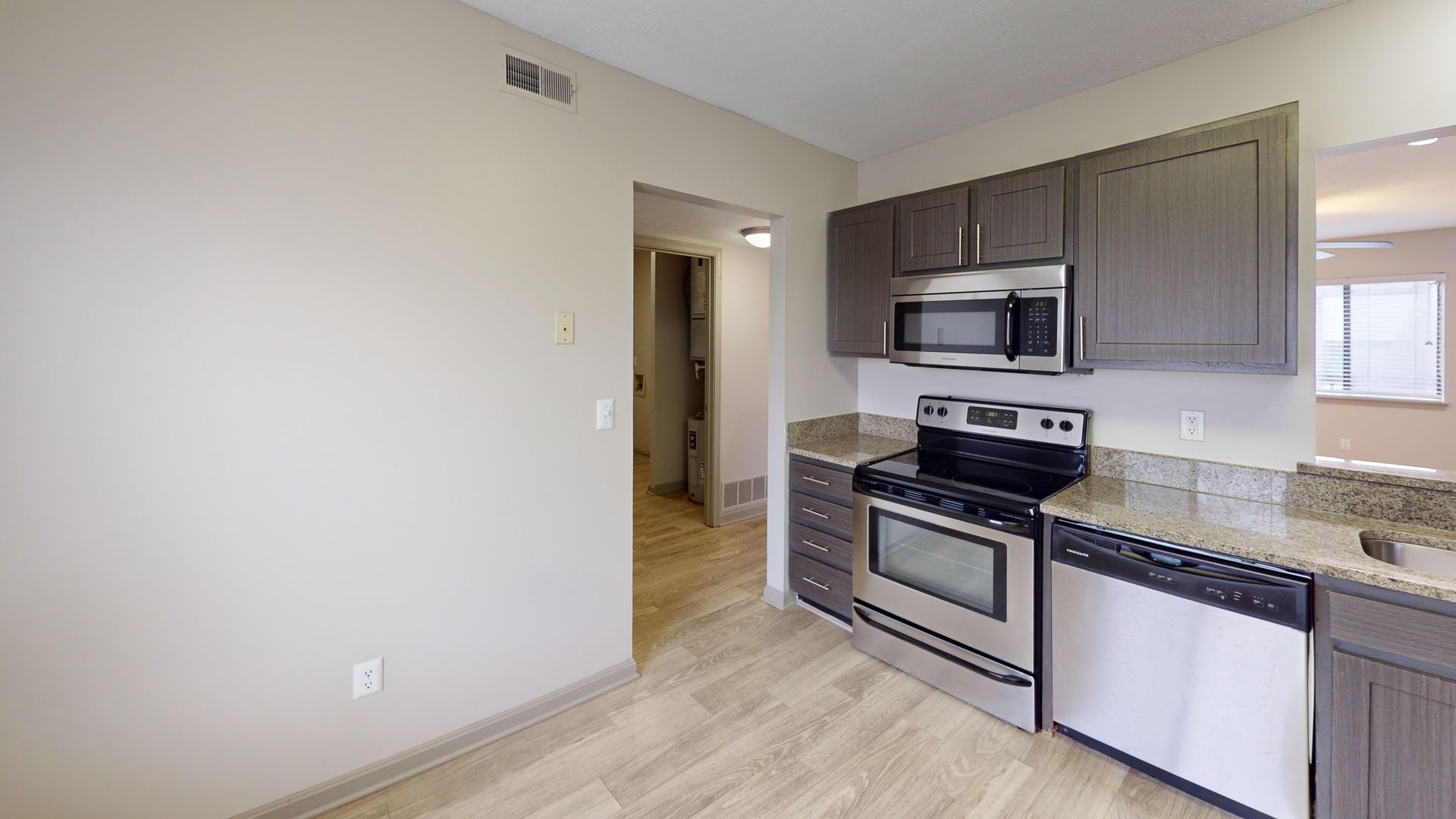 Kitchen with brown cabinets and stainless steel appliances