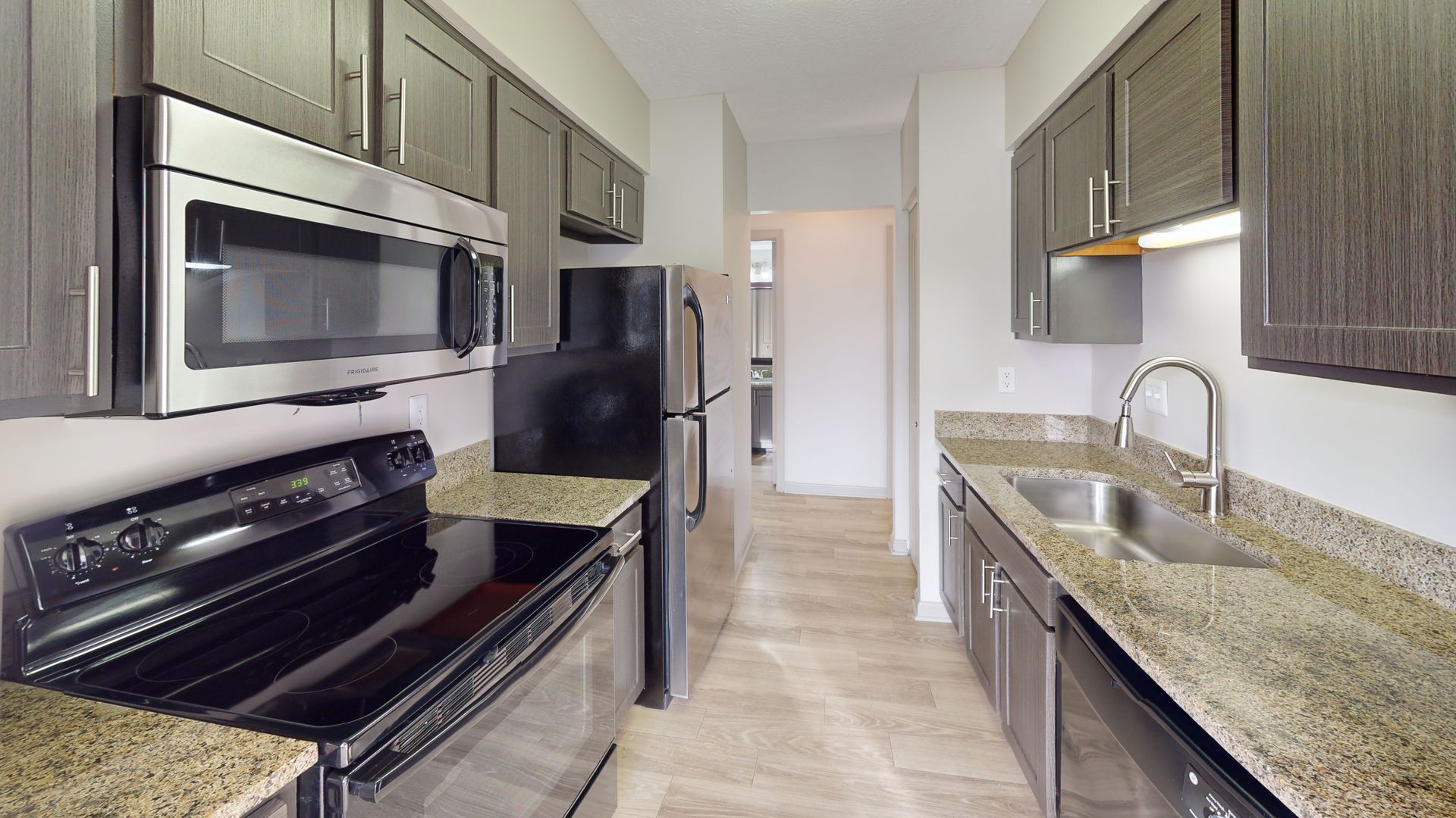 Kitchen with brown cabinets and stainles steel appliances