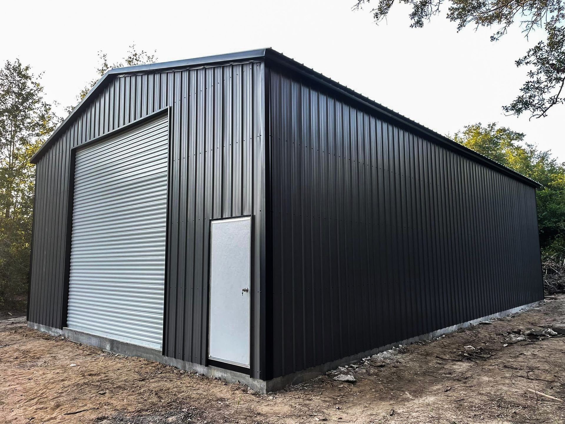 Exterior of a Florida metal storage building with vertical siding and lockable roll-up door