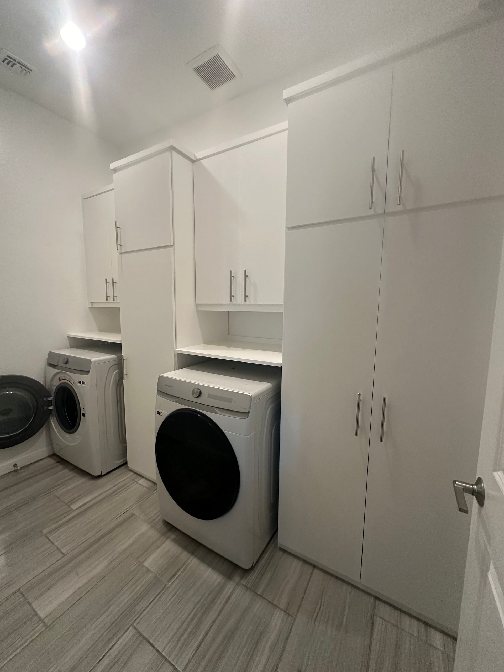 A laundry room with a washer and dryer in it.