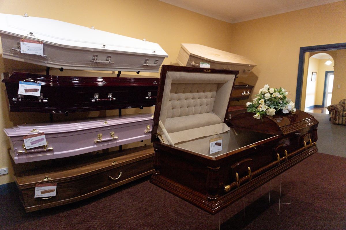 A Room Filled With Lots of Casket Including One That is Open — Becker Family Funerals In Forster, NSW